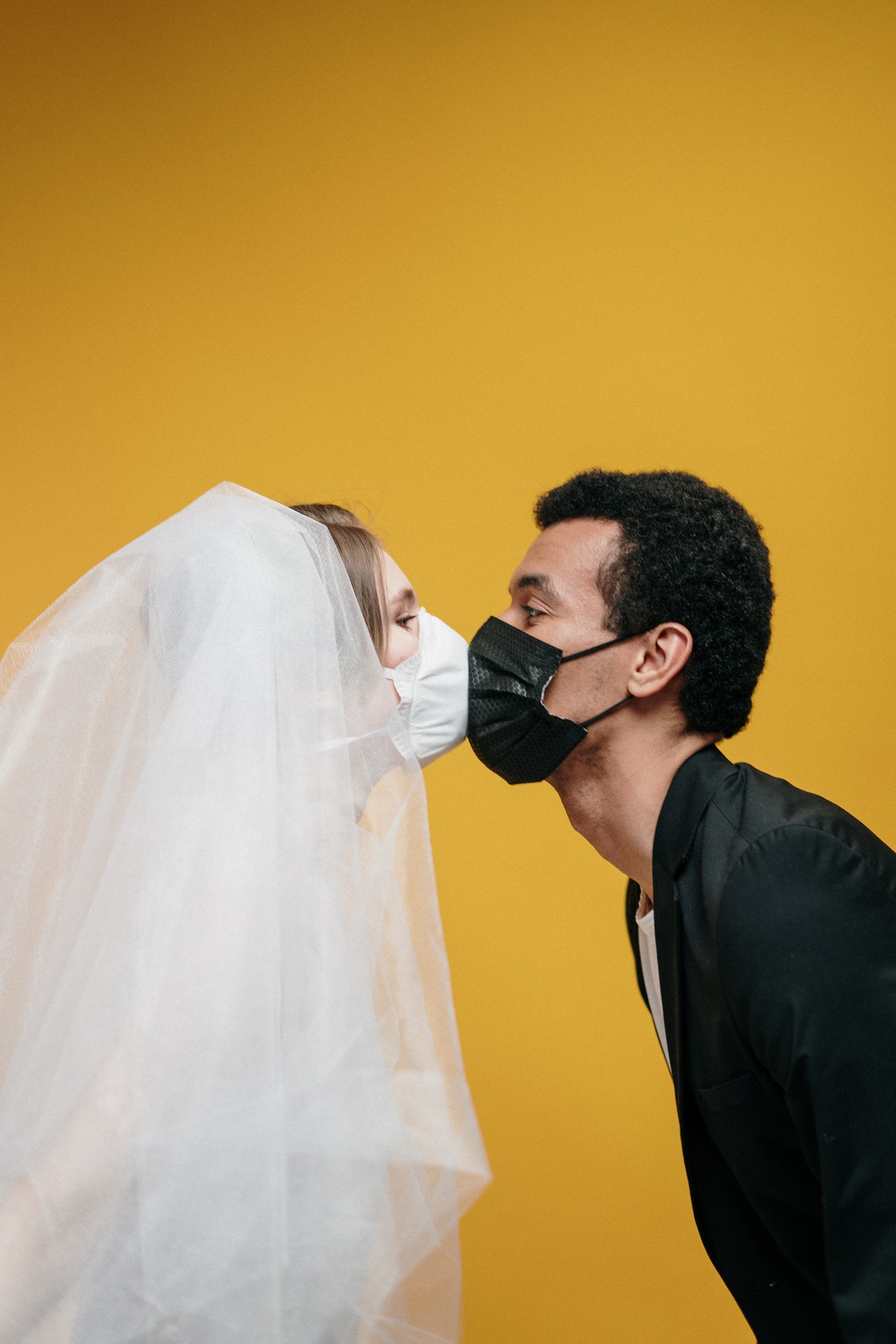 Bride-and-groom-kissing-in-masks.jpg