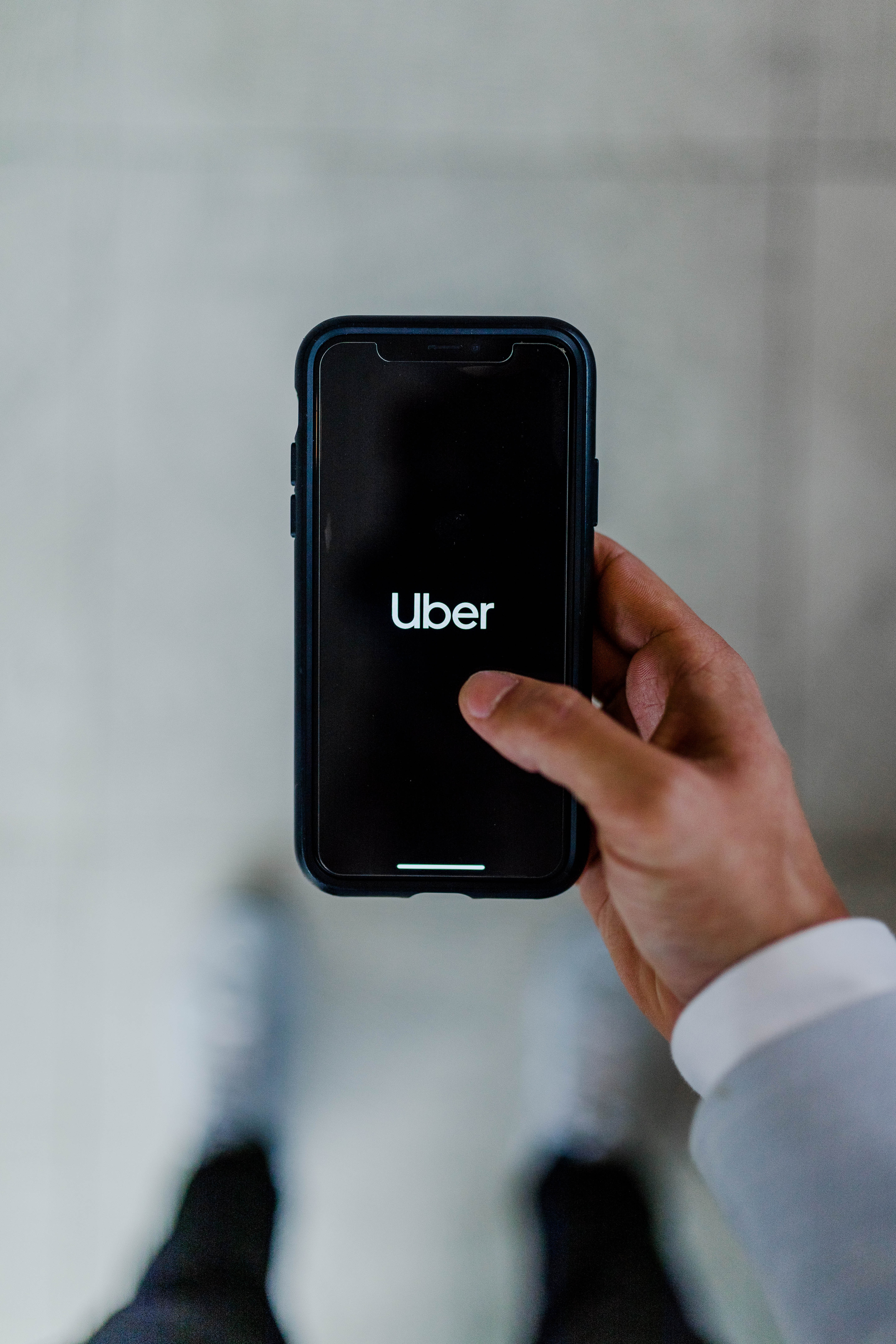 Man-holding-phone-looking-for-uber.jpg