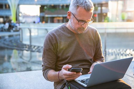 Man-on-phone-and-laptop-.jpg