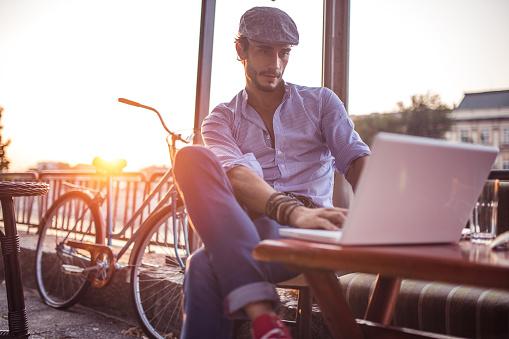 Man-sitting-on-patio-with-laptop.jpg