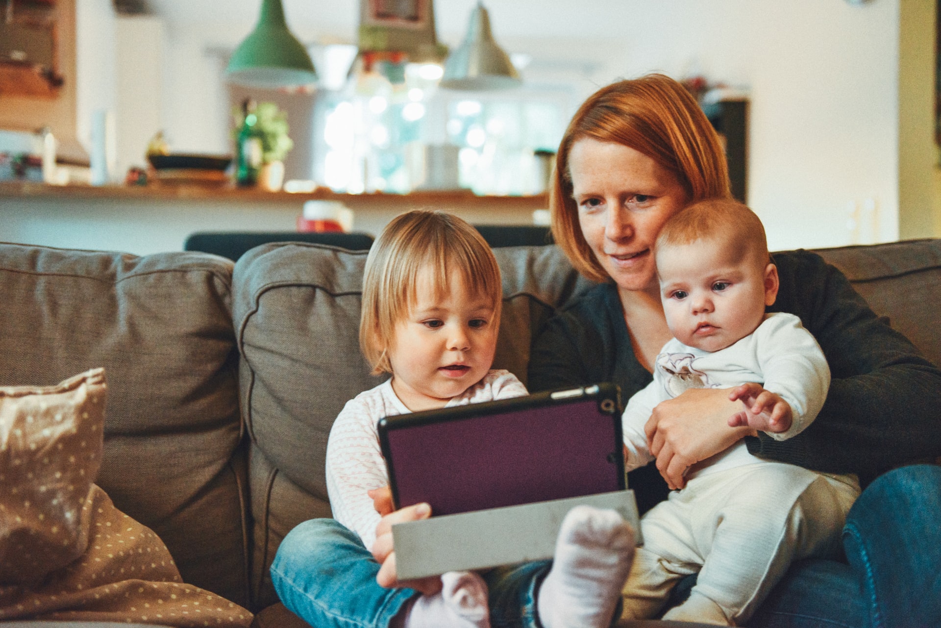 Mother-holding-two-babies-video-chatting.jpg