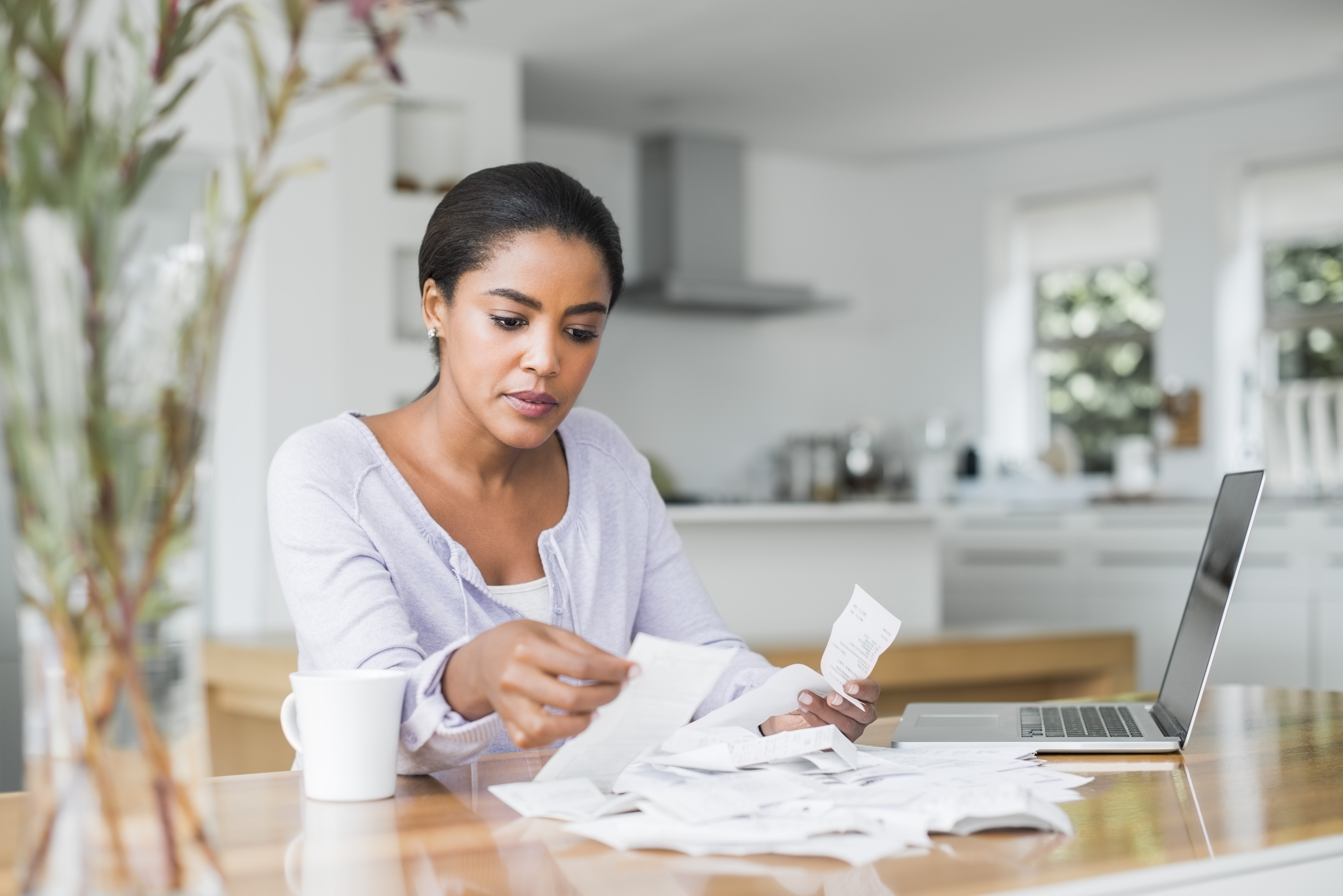 Woman-sitting-at-table-making-a-budget.jpg