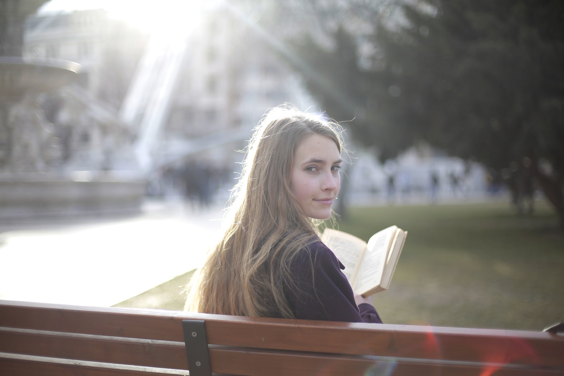 scam-tranquil-woman-reading-book-in-park-3796612.jpg